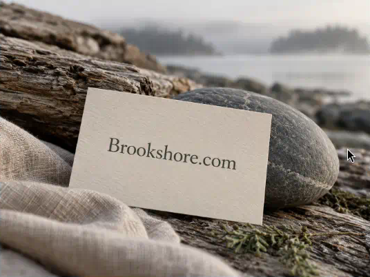 Stone, linen, and weathered timber beside a quiet shoreline